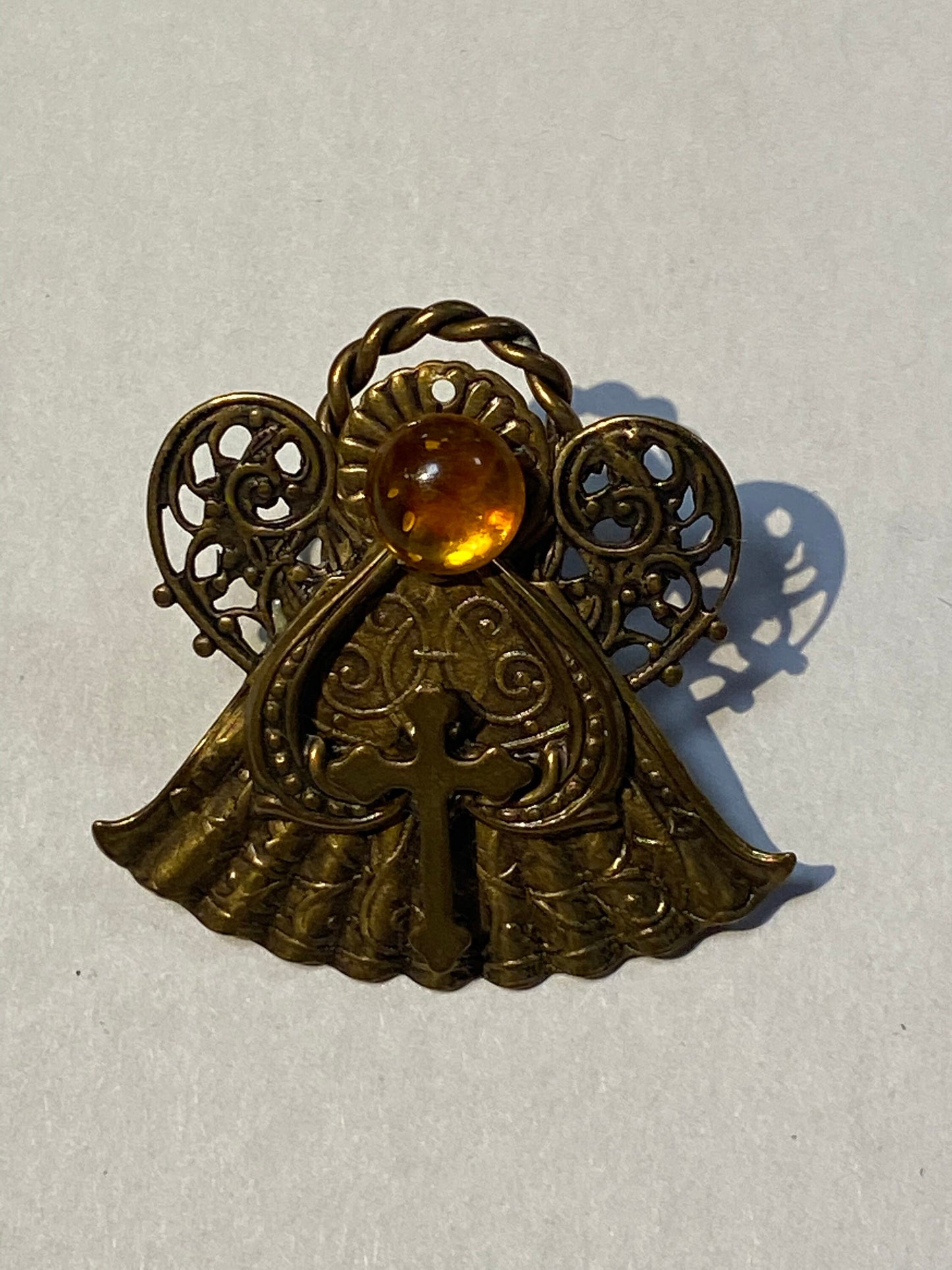 Small religious pin brooch