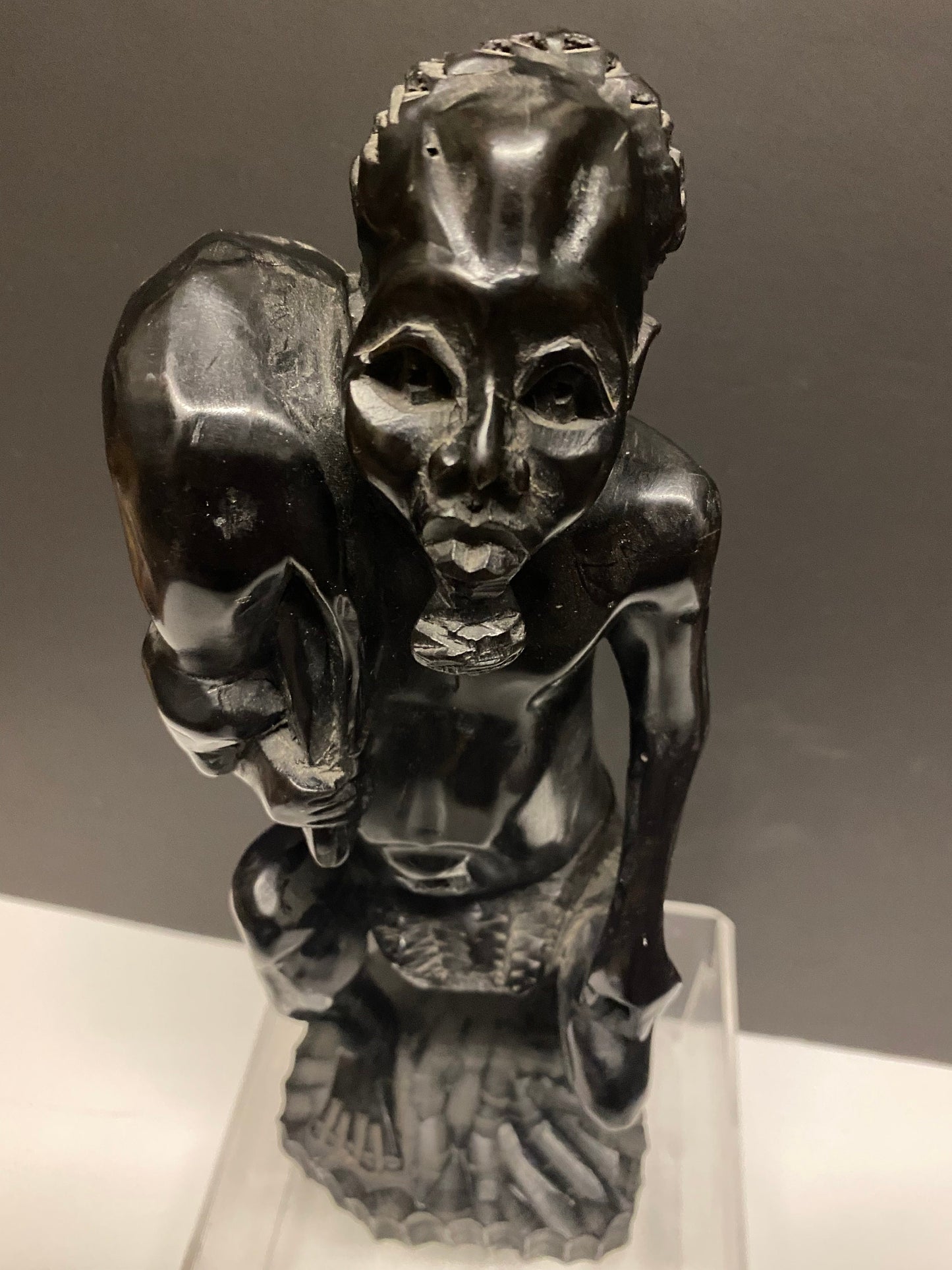 A Foot tall vintage African Ebony wood statue of a man carrying an animal  hunter  well carved  900 grams