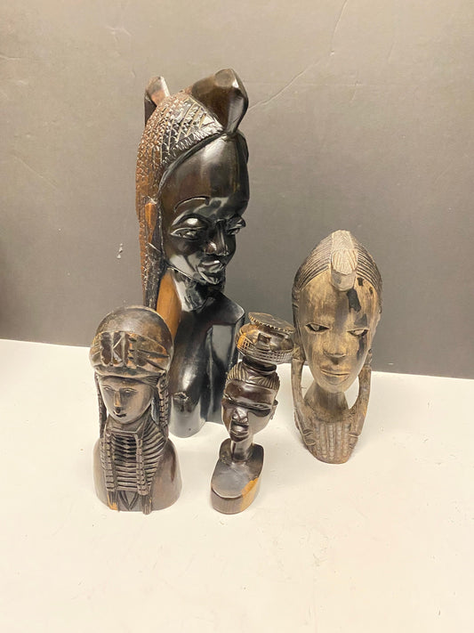 A  Collection of four wonderful hardwood ebony African female busts  6 to 13 inches  1500g of carved wood  wow wow wow