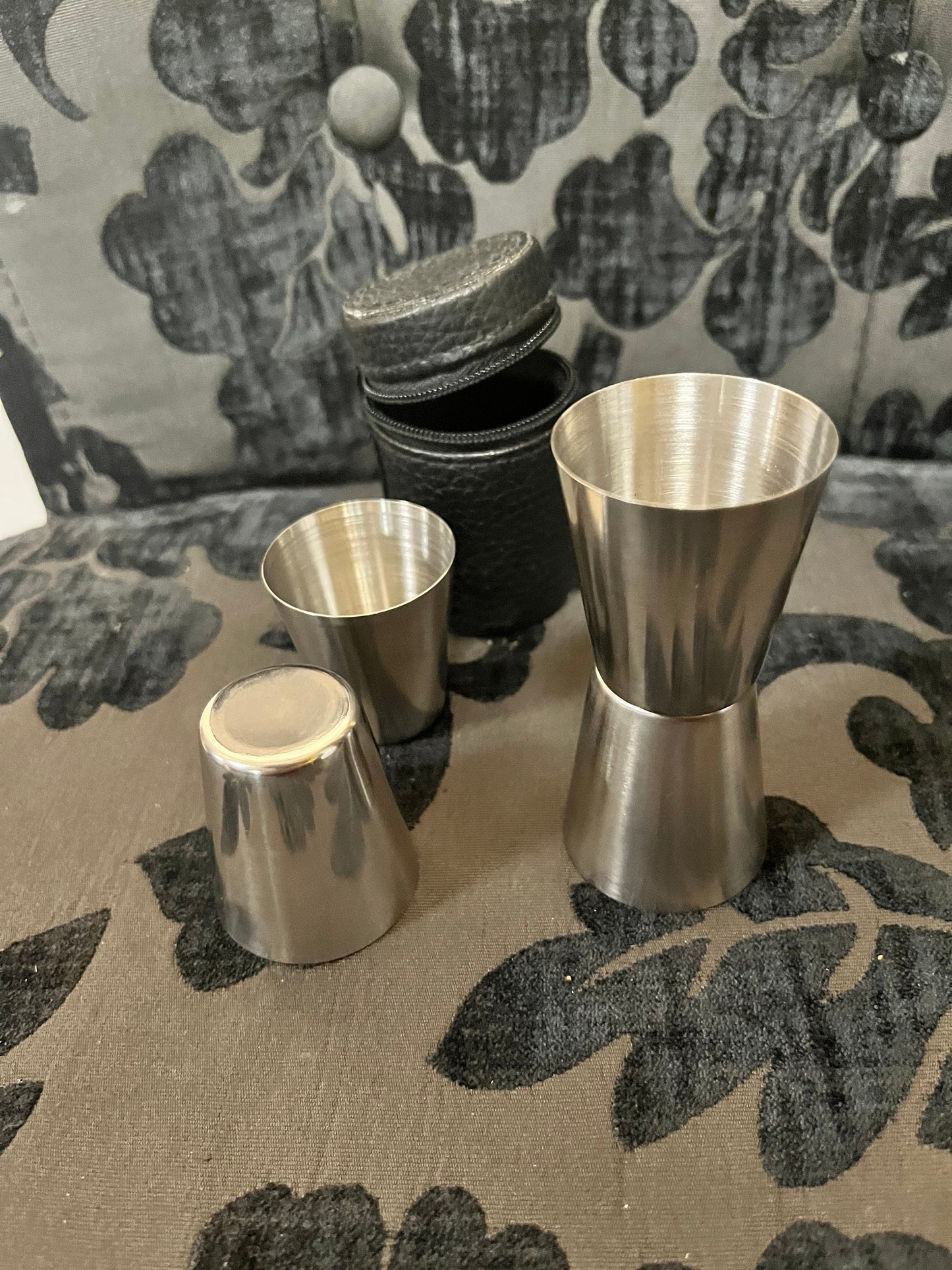 4 metal shot glasses in leather holder  cool  good for picnic or home bar