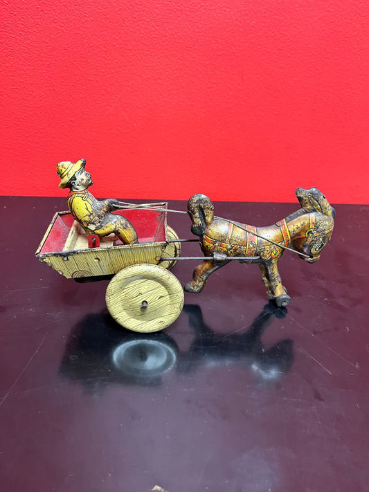 Magical antique tin man riding horse buggy  rare.  8 inches long  good antique  condition