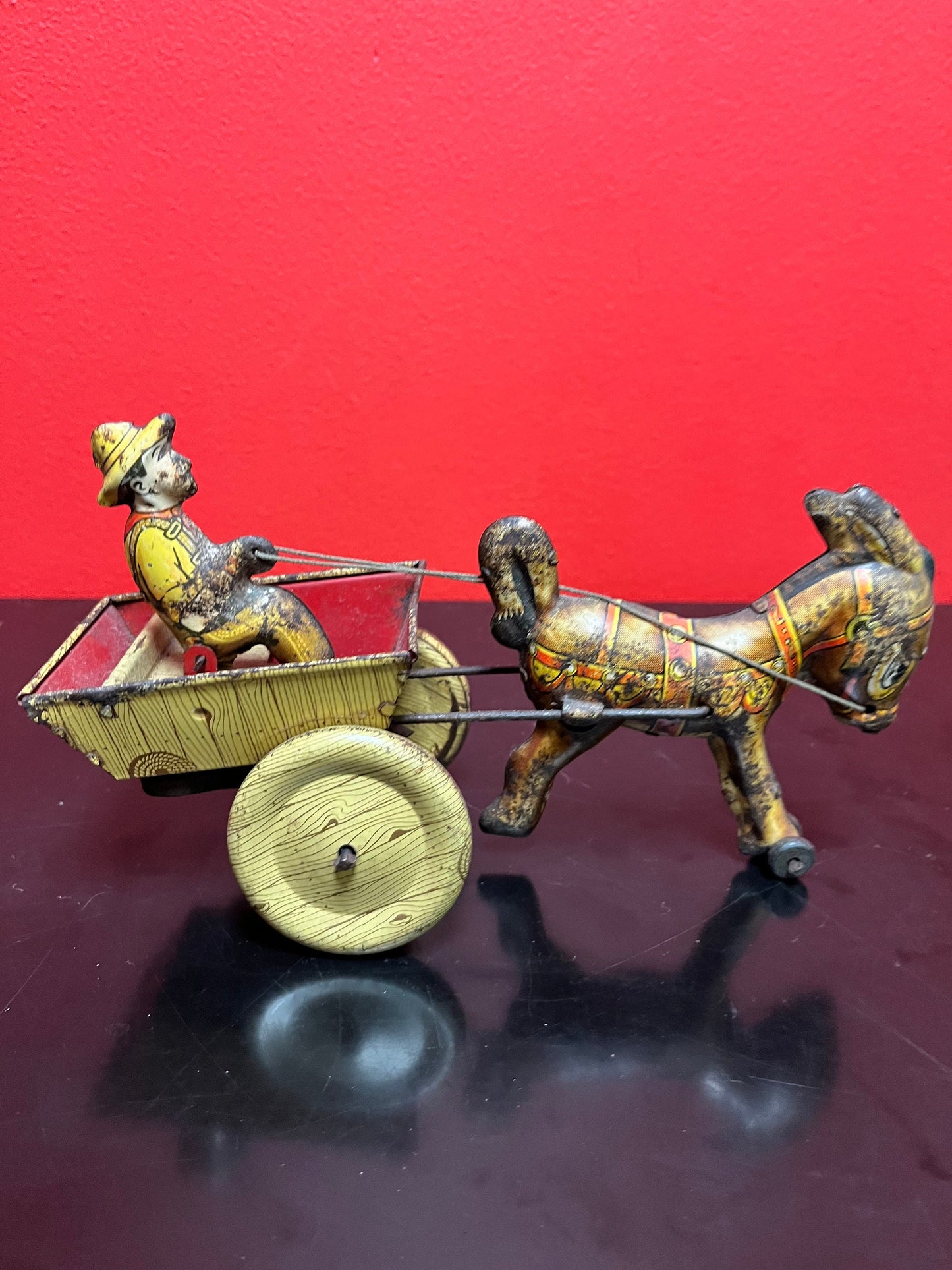 Magical antique tin man riding horse buggy  rare.  8 inches long  good antique  condition