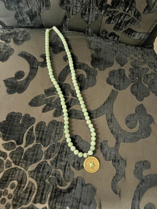 Approx 26 inch long jade necklace with untested gold pendant -