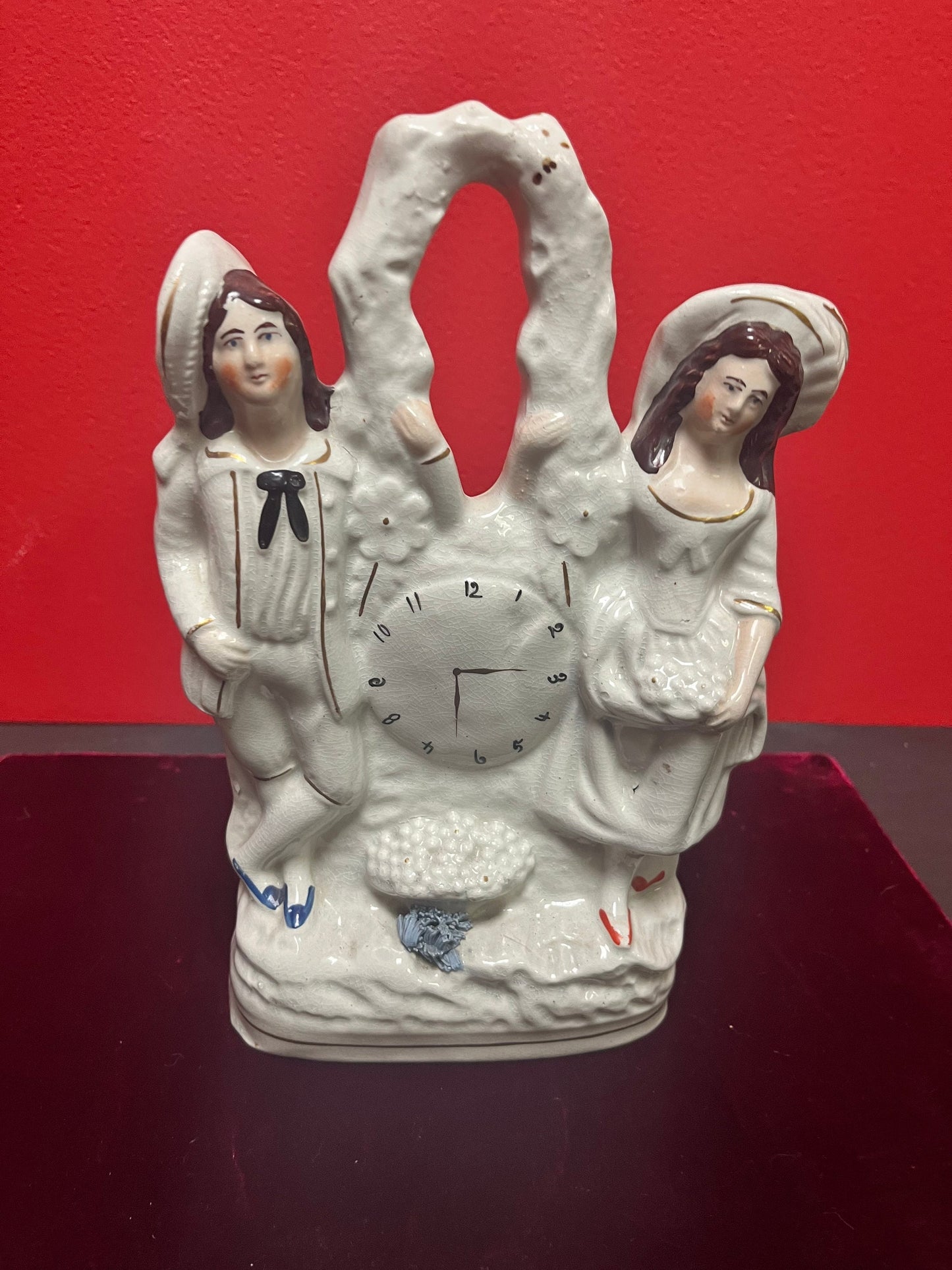 10 inch tall antique Staffordshire couple, holding a clock statue - great antique condition see photos