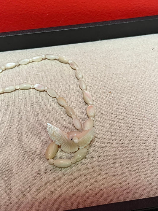 Approximately 21 inch carved shell necklace with bird pendant  lovely detail