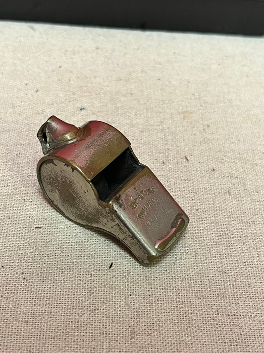 A  The acme thunderer whistle  2 inches long in worn condition