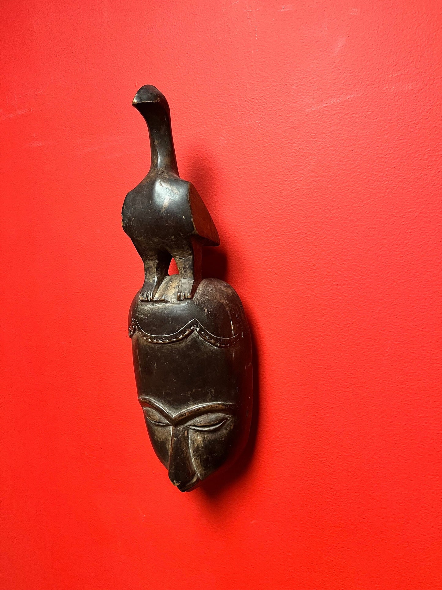 Studying antique ceremonial western African 11 inch tall bird mask   great patina and condition