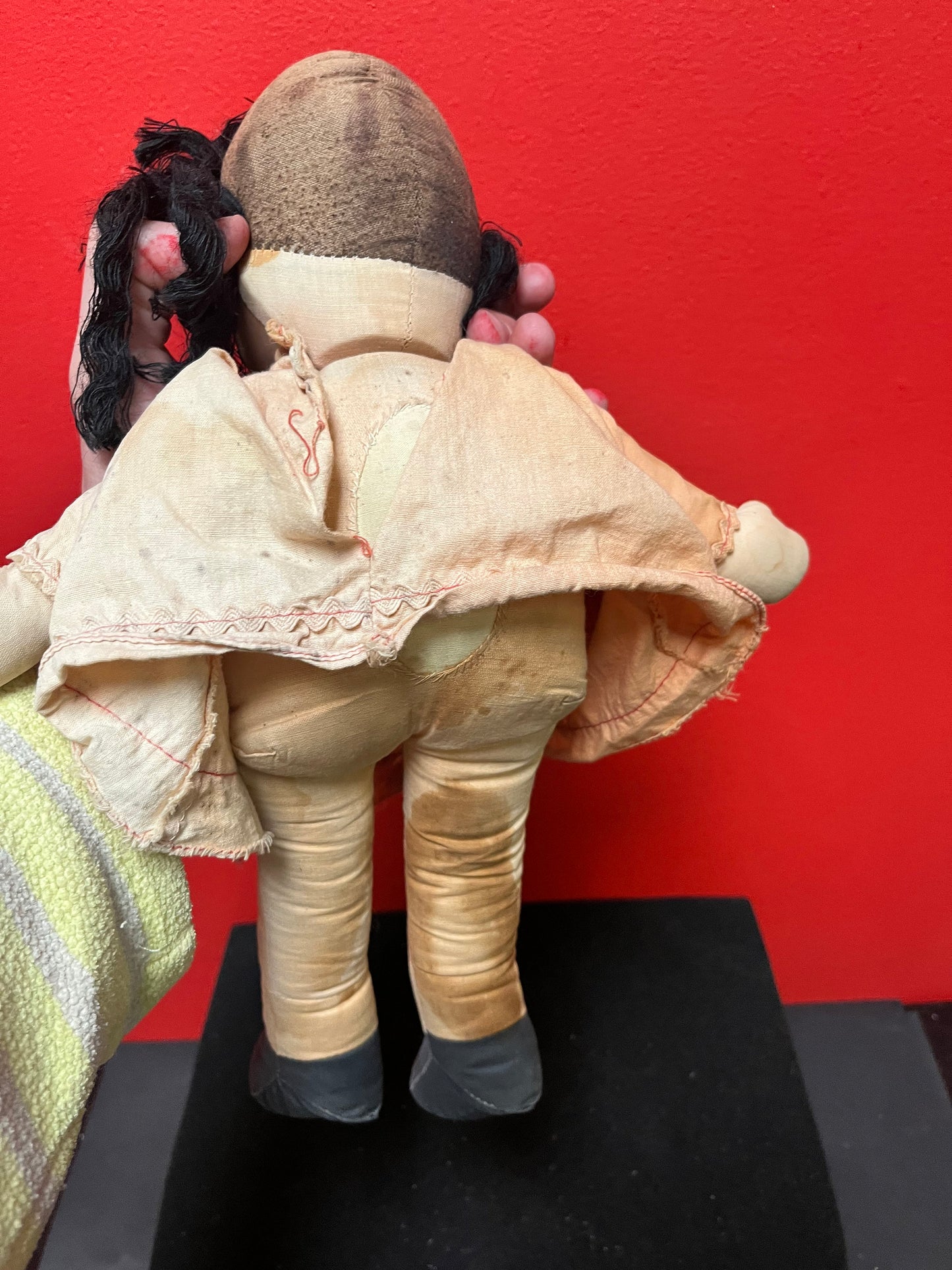 An  Antique 15 inch high Lulu doll in bad condition