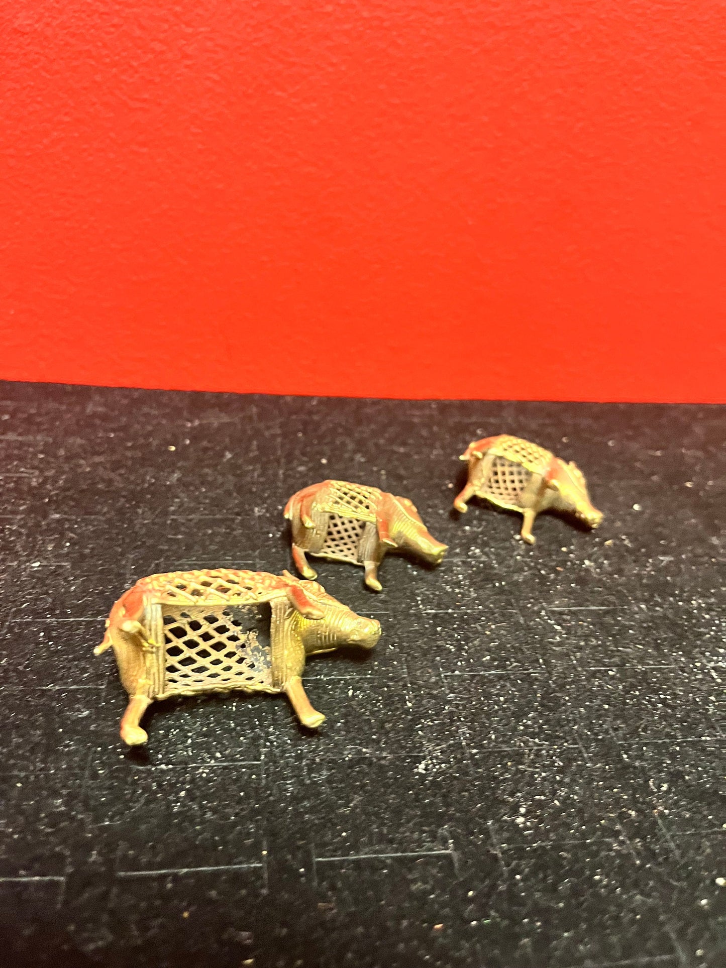 Lovely set of three African Benin brass boars  older  1.5 to 2 inches long each