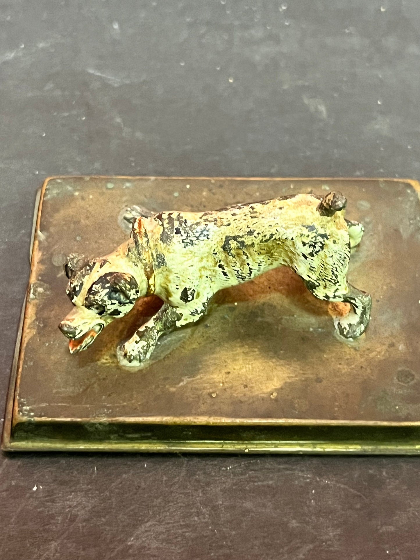 3 inch antique cold, painted bronze dog on stand with registration number  good condition and great patina