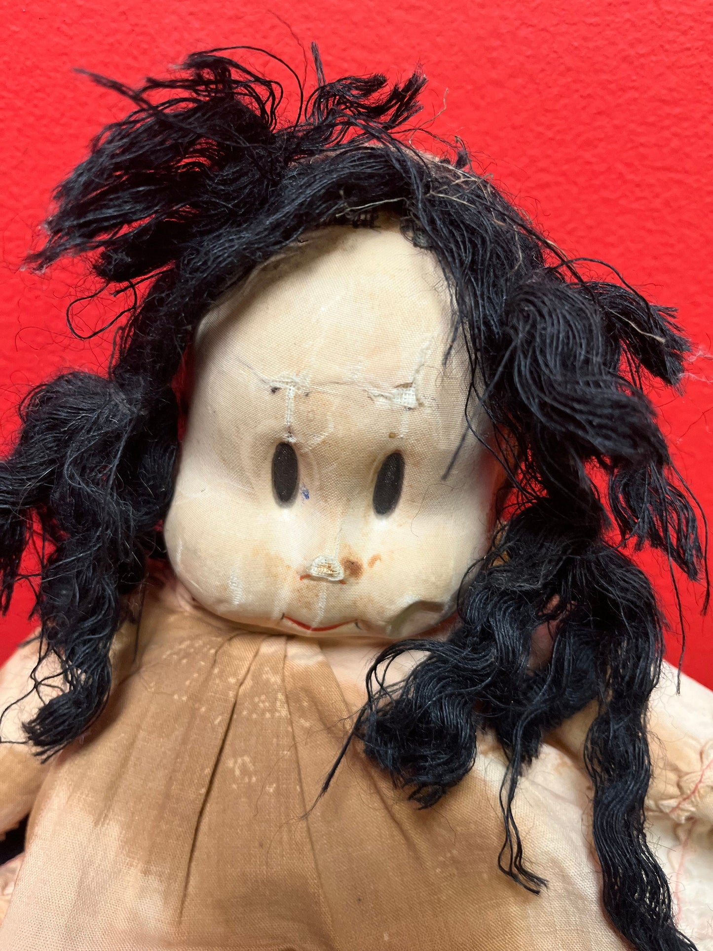 An  Antique 15 inch high Lulu doll in bad condition